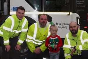 waste collectors with little boy