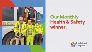 wording - our monthly health & safety winner, photograph of dean with two colleagues in front of a highways vehicel