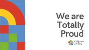 Wording says we are totally proud and there is an image made up of squares of blue, green and red alongside a red and yellow rainbow